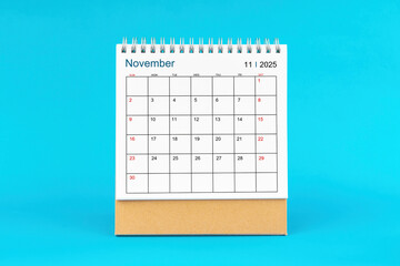 November 2025, Monthly desk calendar for 2025 year on Blue background.