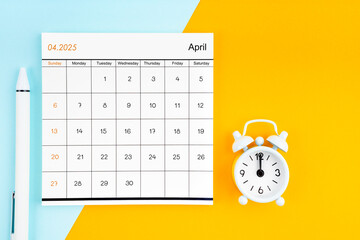 April 2025 Monthly calendar for 2025 year with pen on yellow and blue background.