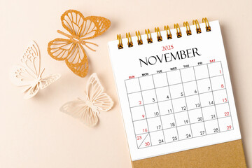 November 2025 desk calendar for the organizer to plan and reminder and butterfly paper on yellow.