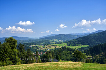 grassy slope of Pilsko mountain and chairlift in Beskid Mountains