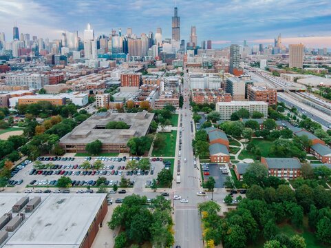 High-angle view of Chicago city streets, buildings, and parking lots. Traffic flows through the urban landscape. West Loop, Chicago, Illinois, United States Of America