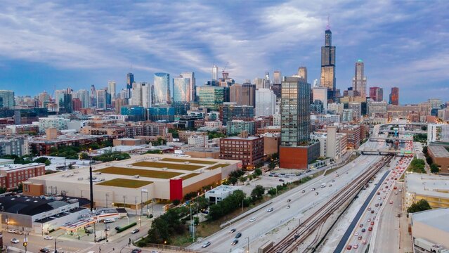 Chicago skyline at twilight, showing busy highway traffic and city development. Urban sprawl and construction. West Loop, Chicago, Illinois, United States Of America
