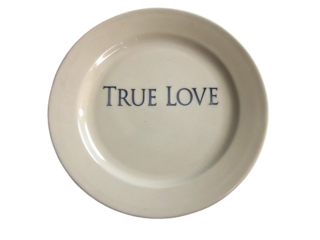 A round decorative plate features the phrase True Love prominently displayed at its center isolated on transparent background