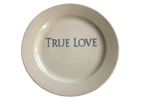 A round decorative plate features the phrase True Love prominently displayed at its center isolated on transparent background