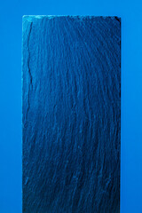 Vivid blue textured slab against a blue background. Modern abstract design.