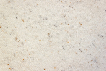 Diagonal texture of sweater quail egg color. Knitted pattern, cozy background. Selective focus, copy space