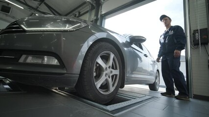Process of automatic suspension diagnostics in a modern auto service. Professional equipment is used to inspect and analyze the condition of the vehicle's suspension and components
