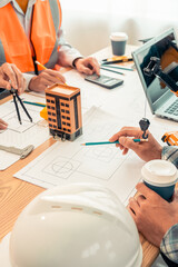 Construction concept: Engineer's hands drawing plans on blue print with architect equipment...