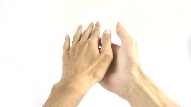 Right hand and left hand rubbing each other on a white background.