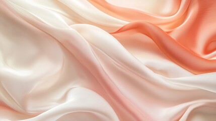 Obraz premium Beautiful silky fabric in soft peach and cream colors flowing gracefully across the surface