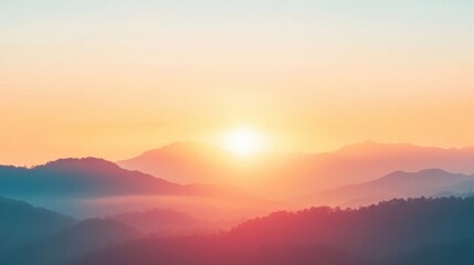 Golden sunlight breaks over the mountains, casting a warm glow on the mist-covered forest valley below at dawn
