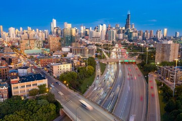 Chicago skyline at twilight, busy highway traffic. Urban landscape, evening rush hour. Interstate...