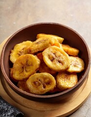 Fried slices of ripe plantains, a traditional and popular snack. Generated image