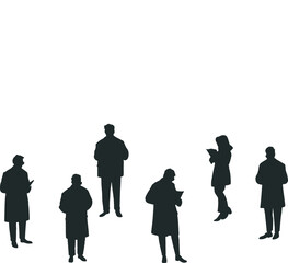 Silhouette of several people focused on reading a book while standing in winter clothes