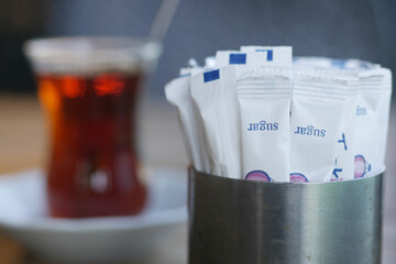 white sugar in a paper packet on table 