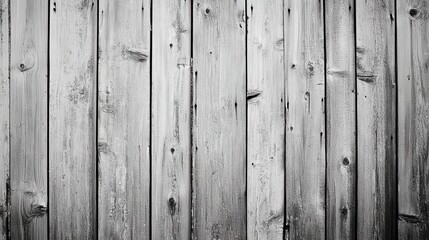 Naklejka premium Grayscale image of weathered wooden planks, showing texture and age. Perfect for rustic backgrounds, textures, or website designs needing a vintage feel.