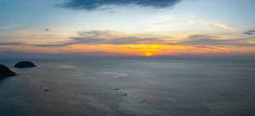 aerial view beautiful sky in sunset at horizon at Kata beach Phuket Thailand. .Scene of colorful red sky in sunset..Gradient color. Sky texture, abstract nature background..