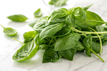 Fototapeta premium A handful of fresh basil leaves on a white surface