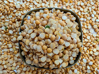 Yellow dry peas in the dark bowl