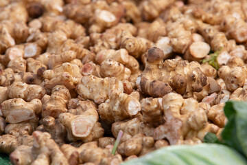 A view of a pile of sunchokes, on display at a local farmers market.