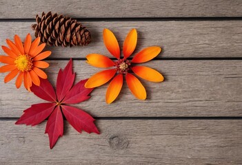 Fototapeta premium A rustic autumn still life with fall leaves and flowers on a wooden background