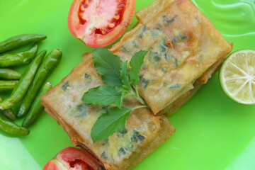 Matabak telur, Indonesian food that has a savory and delicious taste served on a green plate