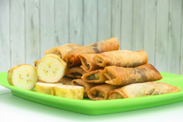 Banana chocolate covered in a thin shell made from flour, dessert from banana and chocolate