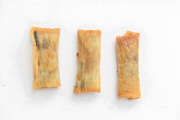 Top of view chocolate banana covered with thin skin made from flour, dessert from banana and chocolate, dessert isolated on white background