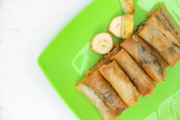 Top of view chocolate banana covered with thin skin made from flour, dessert from banana and chocolate, dessert isolated on white background