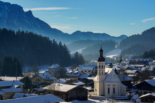 The mountaineering village of Sachrang in Chiemgau, Bavaria, Germany with a view of the Kaiser Mountains in Tyrol, Austria in winter