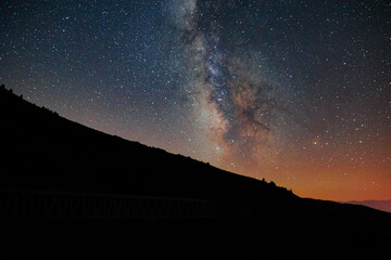 Starry night and silhouette of the hills