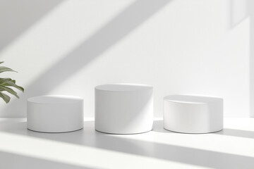 Three round pedestals with pink, blue, and white flowers surrounding them