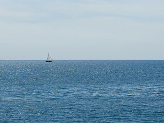 Ocean blue shiny water and clear sunny sky horizon