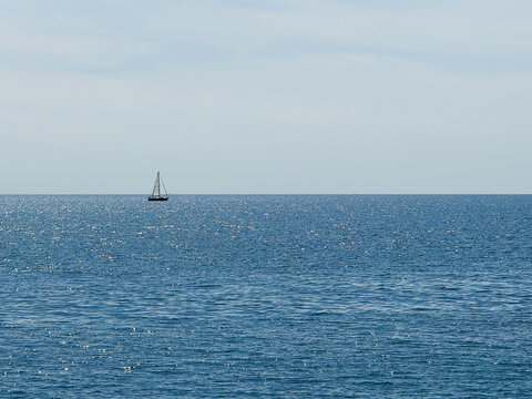 Ocean blue shiny water and clear sunny sky horizon