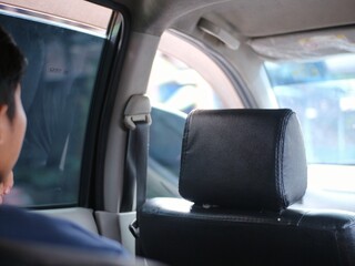 People sit in car seats to go on a road trip