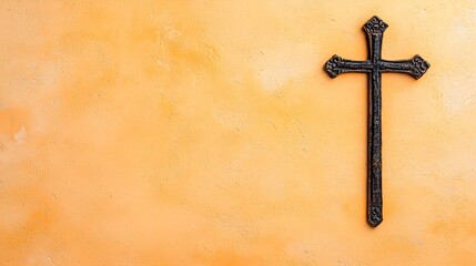 A dark, ornate cross is centered against a textured, peach-colored background.