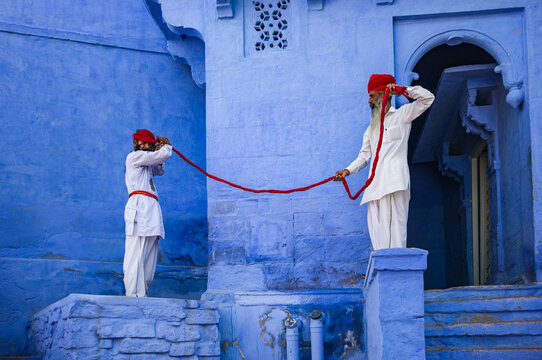 Two indian men wrapping around the head a red turban, Jodhpur, India