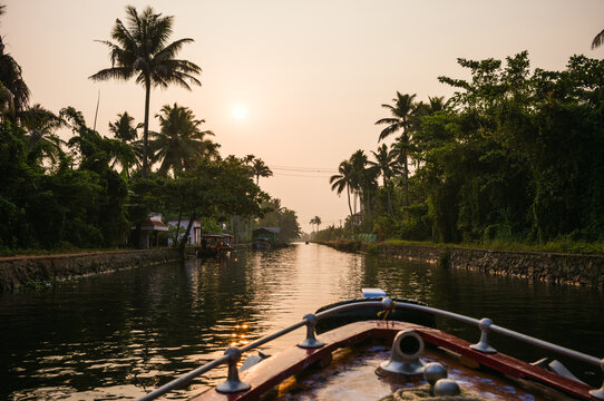 Boat prow in a canal in the backwaters of Kerala at sunset, India