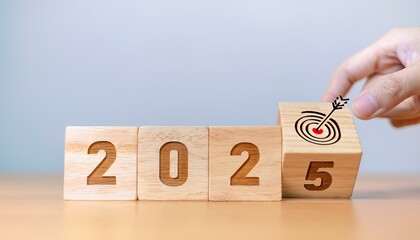Naklejka premium 2025 year with the target which prints screens on wooden cube blocks with ideas for Business plans and goals and strategies that will lead to business success and a better life in the new year