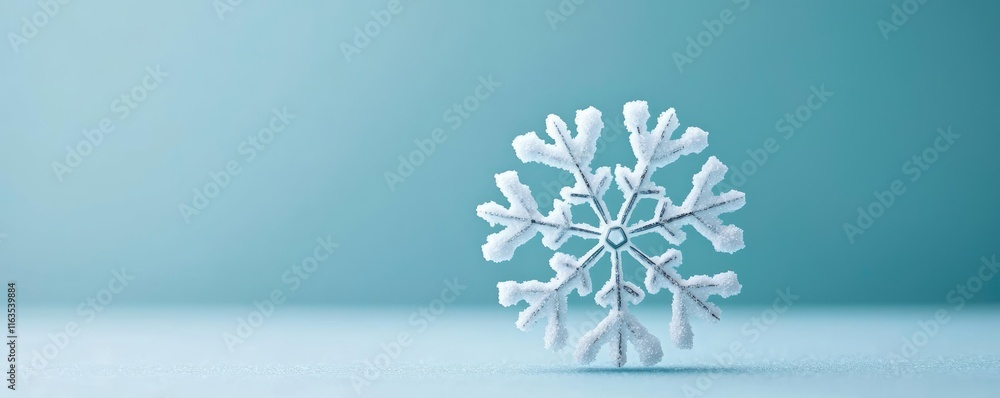 Aufkleber Snowflake abstract background idea. A single, delicate snowflake resting on a smooth surface against a cool background.