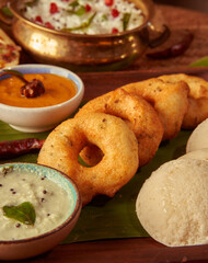 vada sambhar on a table with coconut curry