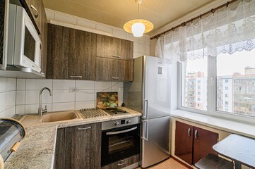 interior apartment kitchen and dining room, refectory area, cooking equipment, table furniture, stove