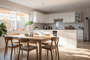 A kitchen with white cabinets and a dining table