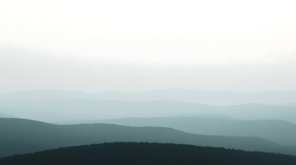 Hazy Mountain Ranges Under a Pale Sky