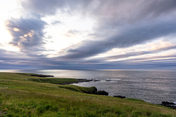 Rocky cliffs along the sea on the Vatnsnes peninsula, located on the east coast of Iceland