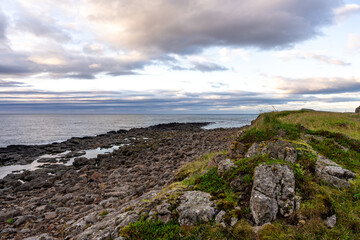 Rocky coastal cliffs on the Vatnsnes peninsula, located along the east coast of Iceland
