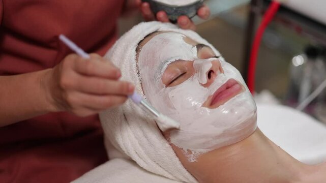 facial mask on face spa treatment. Thai Massage and spa therapy. Beautiful caucasian Woman Getting service aromatherapy massage Spa Treatment
