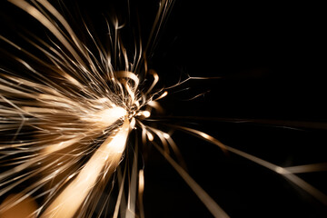 sparks from the grinder glowing in the dark