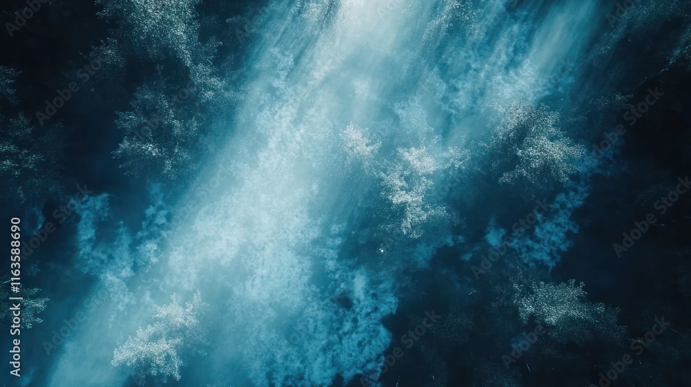 Poster aerial view of a dark forest with a light beam cutting through the trees.
