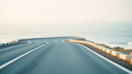 Asphalt Road Winding Along a Coastal Shoreline at Dawn